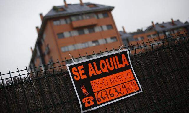 A sign that reads: 'New flat for rent' is hung outside a block of houses on the outskirts of Madrid