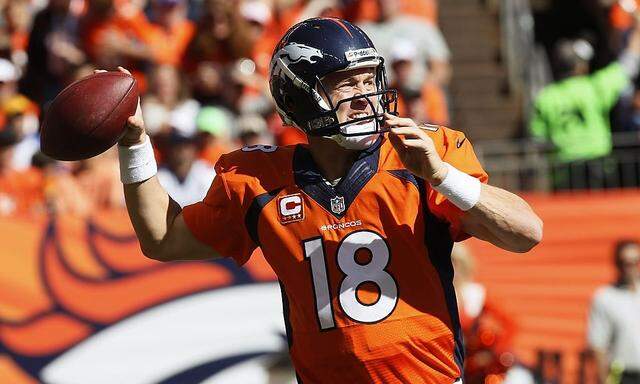 Denver Broncos quarterback Peyton Manning throws against the Philadelphia Eagles in their NFL game in Denver