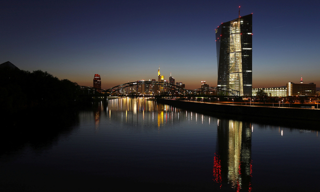 The headquarters of the European Central Bank (ECB) (R) is seen next to the famous skyline in Frankfurt