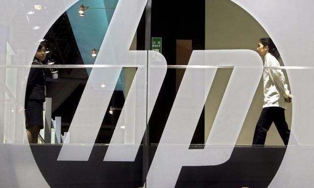 An employee walks past a Hewlett-Packard logo during the International Telecommunication Union (ITU) Telecom World 2006 in Hong Kong in this file photo