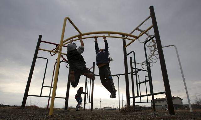 Children play in a playground in the Attawapiskat First Nation