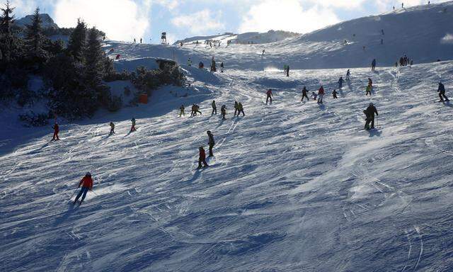 Skiers are on the slope on a sunny winter´s day at the ski resort of Flachau