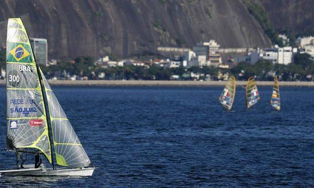 Sailing boats take part in a practice session ahead of the first test event for the 2016 Olympic Games at the Guanabara Bay in Rio de Janeiro