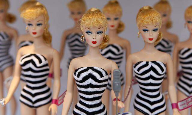 Barbie dolls sit on a display before the Barbie house opening ceremony in Shanghai