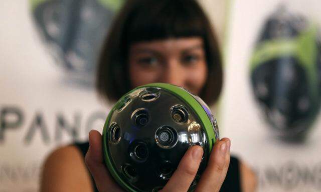 An employeer of German startup Panono displays a 360 degrees camera during the Pioneers festival in Vienna