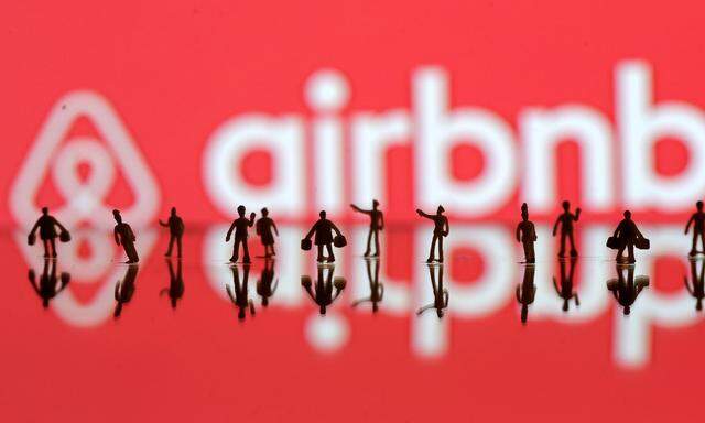 FILE PHOTO: A 3D printed people's models are seen in front of a displayed Airbnb logo in this illustration