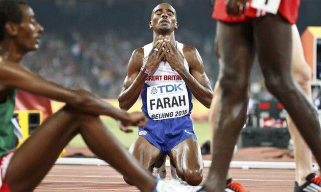 Farah of Britain prays after winning the men's 5000m event during the 15th IAAF World Championships at the National Stadium in Beijing