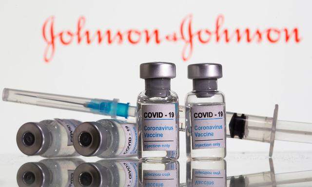 FILE PHOTO: Vials labelled 'COVID-19 Coronavirus Vaccine' and sryinge are seen in front of displayed J&J logo in this illustration