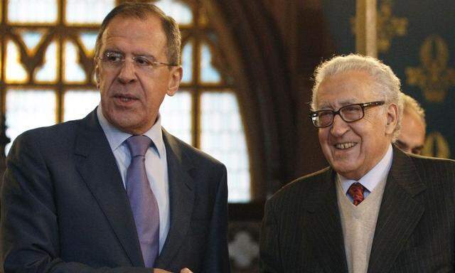 Russia's Foreign Minister Lavrov shakes hands with U.N.-Arab League peace mediator Brahimi in Moscow