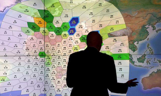 File photo of a member of staff at satellite communications company Inmarsat working in front of a screen showing subscribers using their service throughout the world, at their headquarters in London