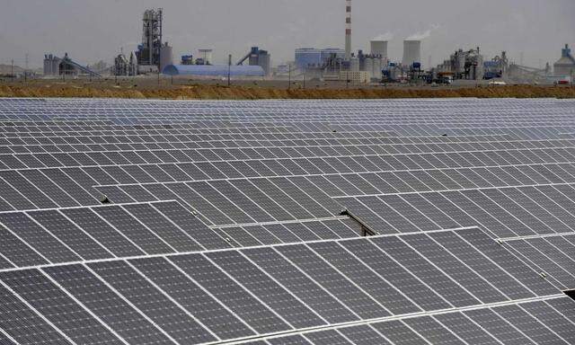 File photo of a solar power plant near a thermal power plant in Aksu