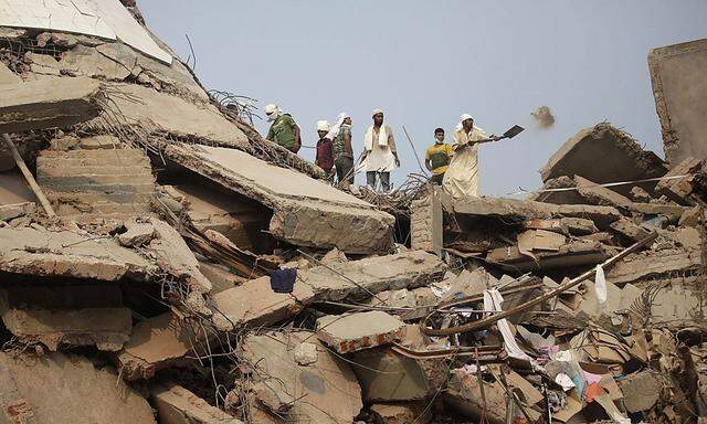 Rescue workers look for trapped garment workers at the collapsed Rana Plaza building in Savar