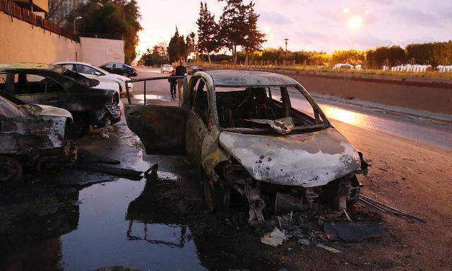 Burned cars are seen at the site of the headquarters of Libya's Foreign Ministry after suicide attackers hit in Tripoli