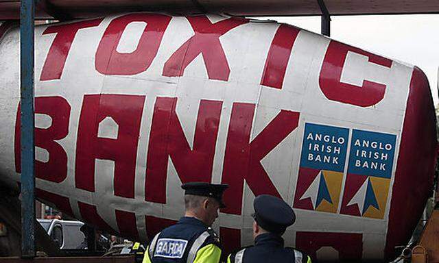 Police stand beside a cement truck which rammed the front gates of the Irish Parliament in Dublin Wed