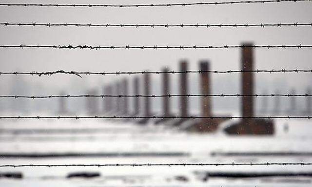 Chimneys are seen through barbed wires during a visit by French secondary school students at the Ausc
