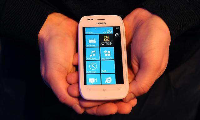 A man holds the new Nokia Lumia 710 smartphone at the Nokia World event in London