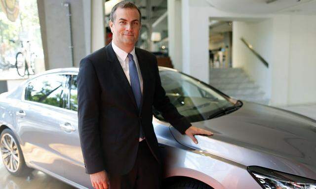 Maxime Picat, CEO of Peugeot brand, poses in front of a Peugeot 508 car at the company headquarters in Paris