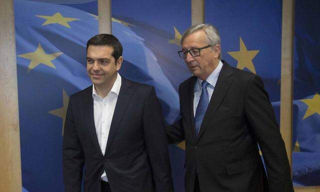 Greek Prime Minister Alexis Tsipras arrives next to European Commission President Jean-Claude Juncker for a meeting ahead of a Eurozone emergency summit on Greece in Brussels