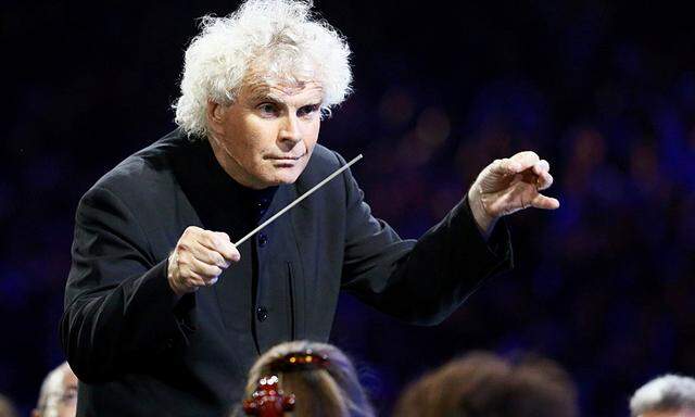 Conductor Simon Rattle takes part in the opening ceremony of the London 2012 Olympic Games at the Olympic Stadium