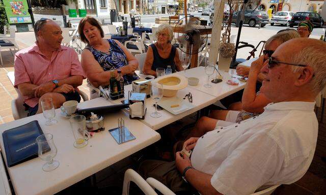 British residents discuss in a restaurant after Britain voted to leave the European Union in the EU Brexit referendum, in Javea near Alicante
