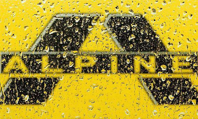 Alpine Bau logo is pictured through raindrops on a window in Vienna