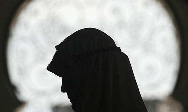 A Muslim woman prays at the Baiturrahman grand mosque in Banda Aceh