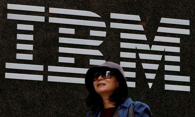 A woman passes by the IBM offices in New York