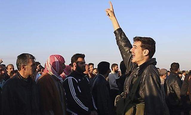 Protesters shout slogans against Syrian President Bashar al-Assad near the town of Qusair