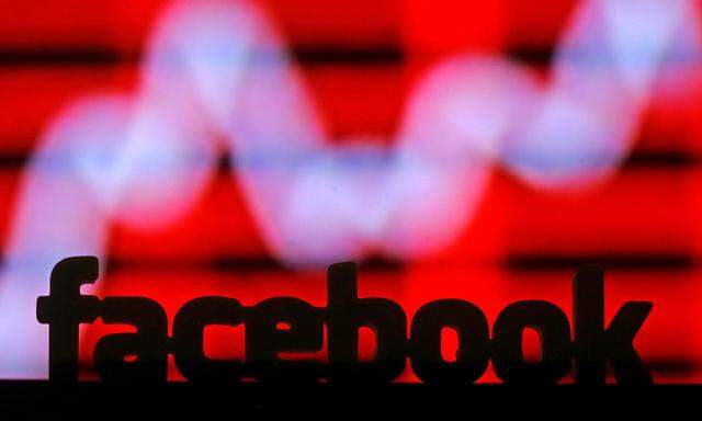 A 3D printed Facebook logo is seen in front of a displayed stock graph in this illustration taken