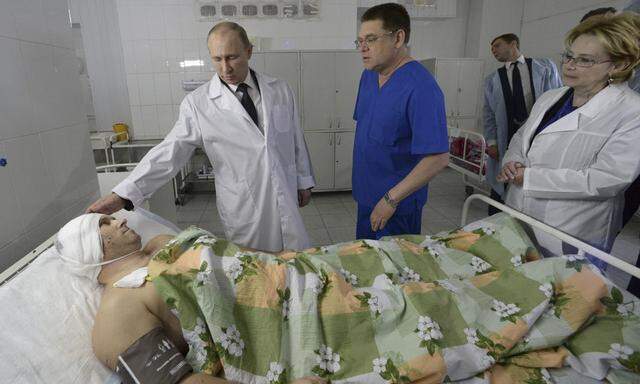 Russia´s President Putin meets a survivor of one of the recent bombings at a local hospital in Volgograd