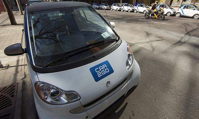 A line of Car2Go cars take up a block of parking in downtown Calgary