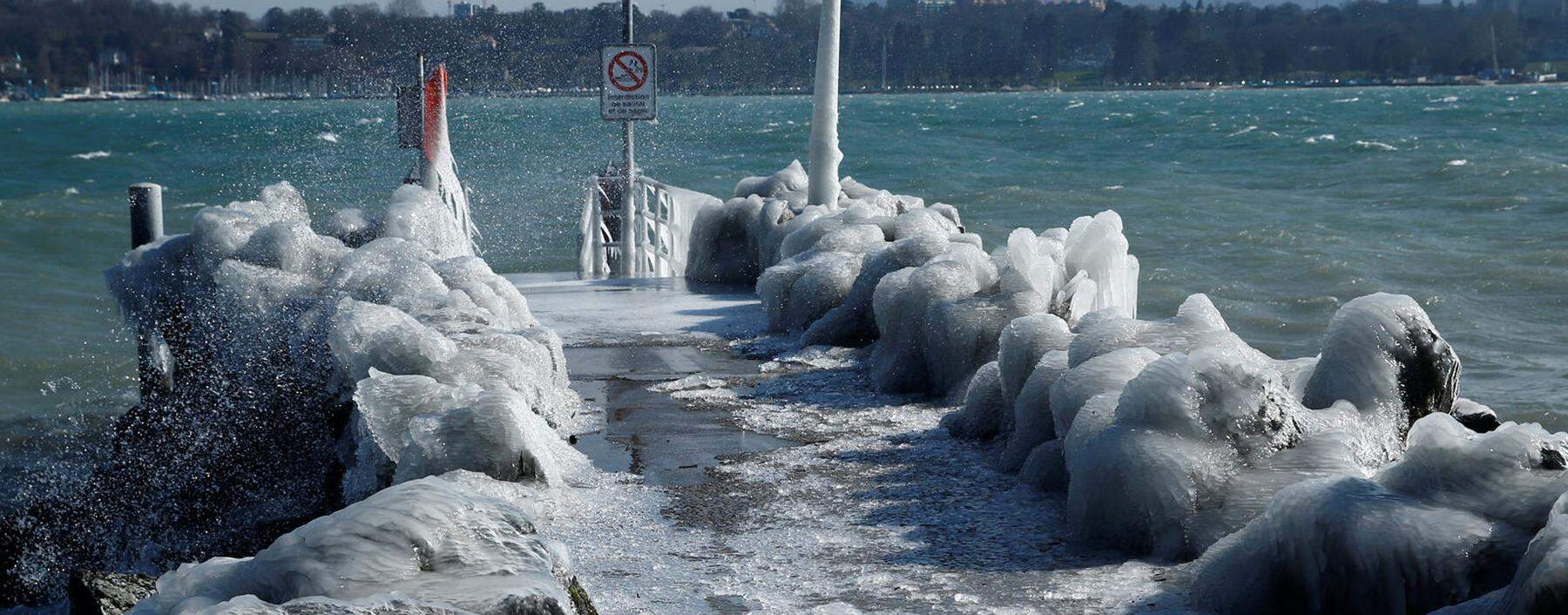 A frozen pier is seen during a windy winter day near Lake Leman in Geneva