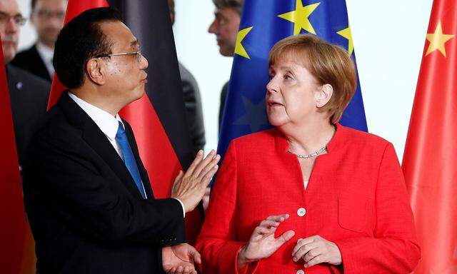 German Chancellor Angela Merkel and Chinese Prime Minister Li Keqiang speak before signing the treaties at the chancellery in Berlin