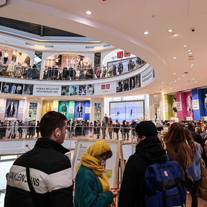Customers queue to enter a Uniqlo store in Moscow