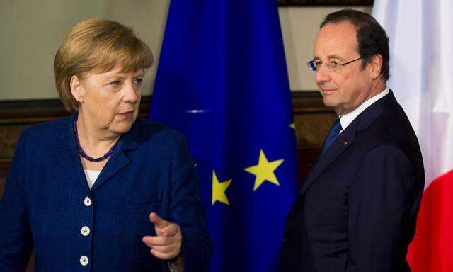 German Chancellor Merkel and French President Hollande walk past a European Union flag at the city hall in Stralsund