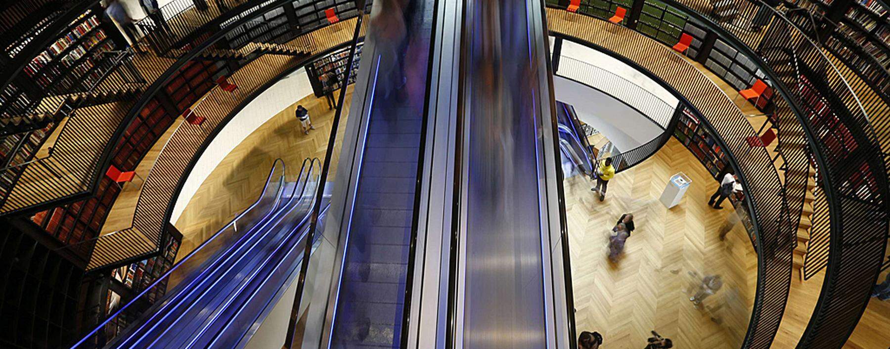 Visitors travel on an escalator after the opening of Birmingham Library in central England