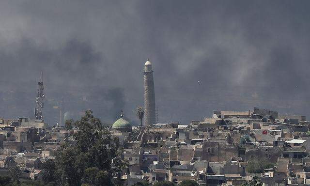 A smoke rises above the old city as Iraqi forces fight Islamic State militants in Mosul