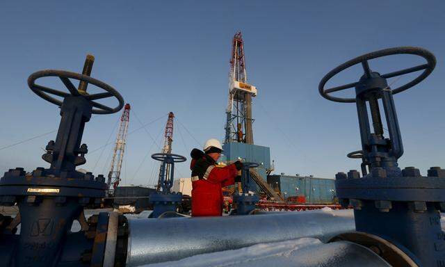 File photo of a worker checking a valve of an oil pipe at the Lukoil company owned Imilorskoye oil field outside the West Siberian city of Kogalym
