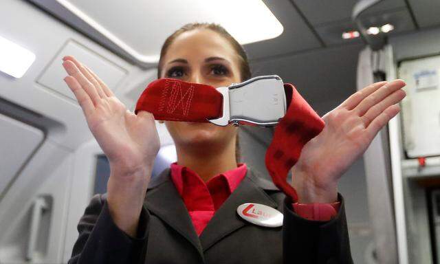 A flight attendant gives safety instructions to passengers aboard a Laudamotion Airbus A320 plane in Duesseldorf