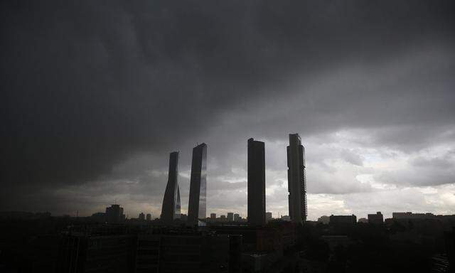 A general view of the Four Towers Business Area underneath dark clouds in Madrid