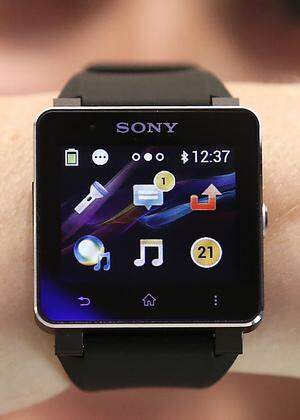 A model poses with a Sony SmartWatch 2 at the Sony booth during a media preview day at the IFA consumer electronics fair in Berlin