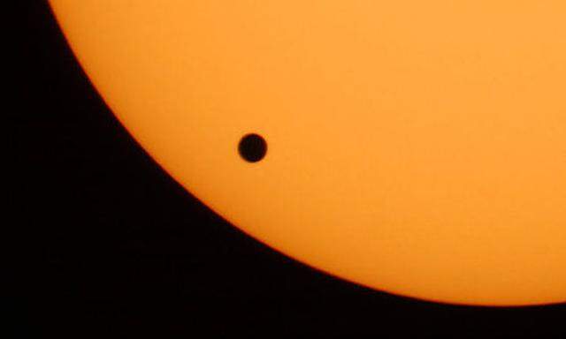 FILE - The planet Venus, black spot, crossing the sun is  photographed through a telescope at Planeta