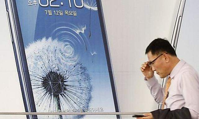 A man uses his mobile phone at a Samsung Electronics store in the company's main office building in Seoul