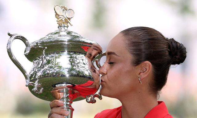 FILE PHOTO: Australian Open champion Australia's Ashleigh Barty poses with the trophy during a photo shoot at the Royal Exhibition Building in Melbourne