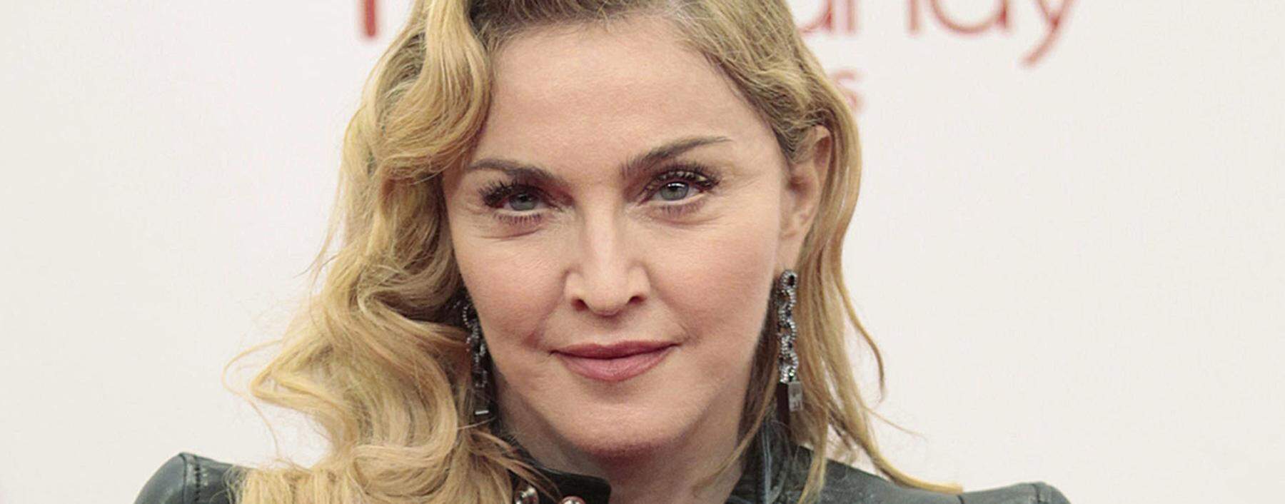 US singer Madonna arrives to promote her latest gym in her Hard Candy Fitness centre chain in Berlin