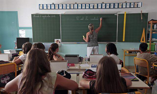 Elementary school children are seen in a classroom on the first day of class in the new school year in Nice