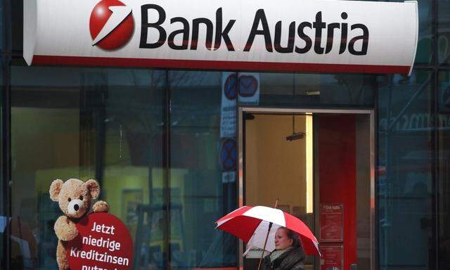 A woman passes a branch of Bank Austria in Vienna