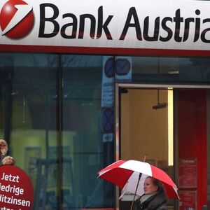 A woman passes a branch of Bank Austria in Vienna