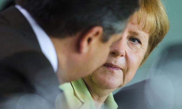 German Chancellor Merkel talks with Economy Minister Gabriel before cabinet meeting at Chancellery in Berlin