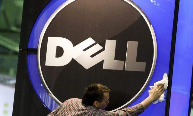 A man wipes logo of Dell IT firm at CeBIT exhibition centre in Hannover